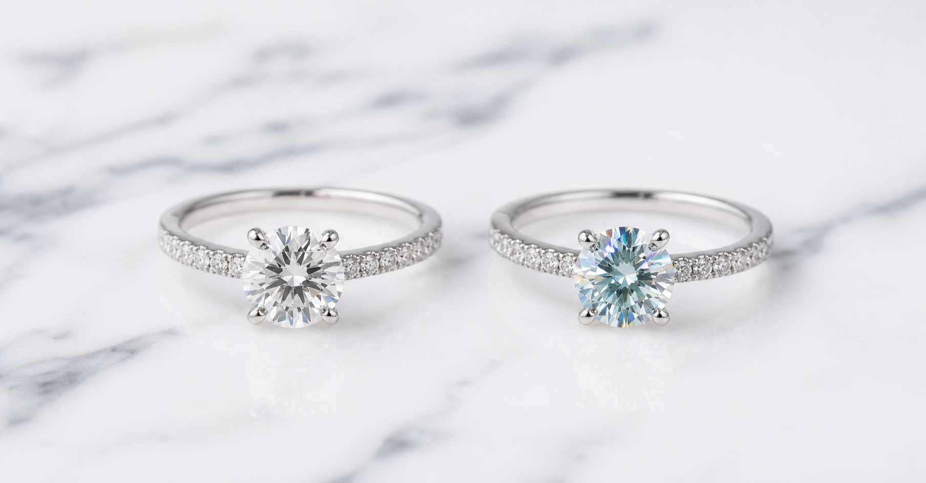 Moissanite vs diamond rings side by side on marble surface